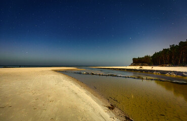 Night scenery of the Piasnica River by the Baltic Sea in Debki, Poland