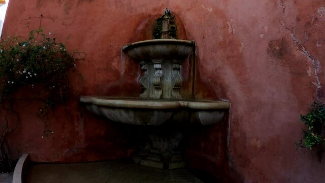 Seville, Spain, September 12, 2021: SLOW MOTION SHOT - Fuente de la Calle Juderia, artistic fountain in Juderia, the Jewish quarter of Sevilla, Andalucia, Spain.