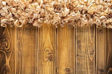 Wood shavings at table background. Wooden shaving on old plank board texture