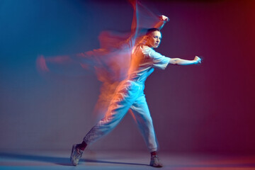 Dancing modern energetic sports girl moving, waving hand. Breakdancer in colourful neon studio...