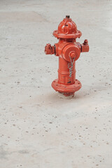 Obraz na płótnie Canvas Minimalistic shot of red fire hydrant sticking out from sandy ground.