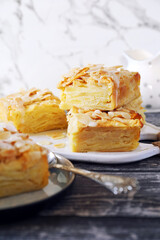 French cuisine. Invisible apple tart, almond petals dressing