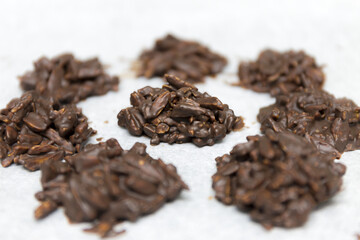 Chocolate rocks and almonds on white background