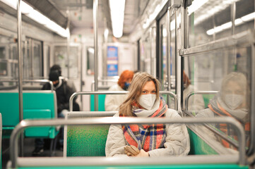 young woman with mask in a train on the subway