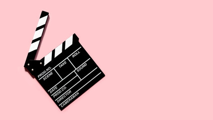 movie clapperboard for shooting videos and movies on a pink background copy space