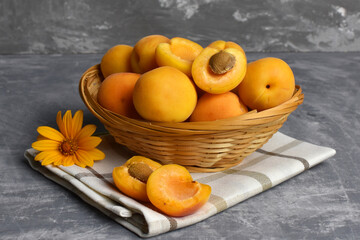 Obraz na płótnie Canvas ripe fruits apricots in a wicker basket summer fruits