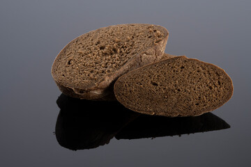 homemade bread on black glass with reflection