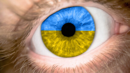Man with the color of the eyes of flag Ukraine. Male eye with a Ukrainian banner