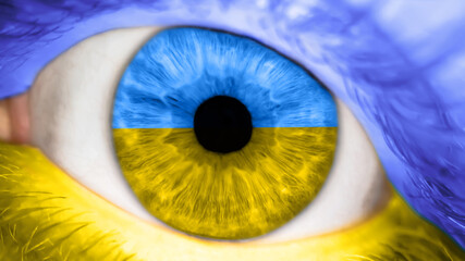 Man with the color of the eyes of flag Ukraine. Male eye with a Ukrainian banner