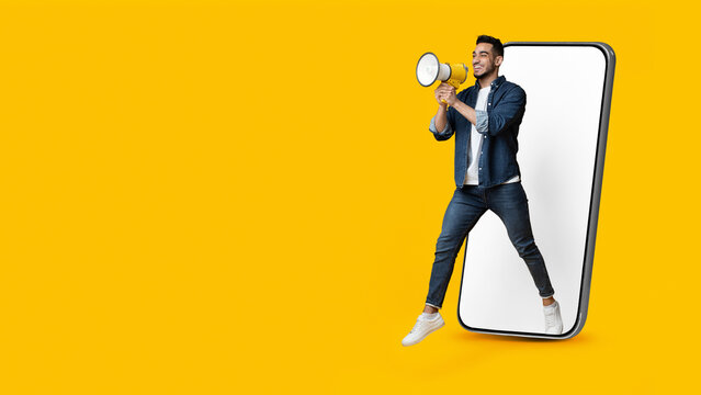Man jumping out of smartphone with empty screen, making announcement