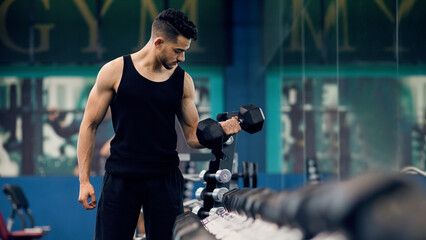 Bodybuilding Concept. Muscular Young Arab Man Training With Dumbbells At Gym