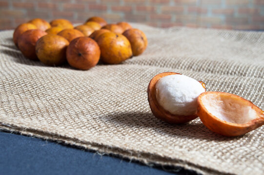 Small round fruit with yellow skin and white pulp named bacupari