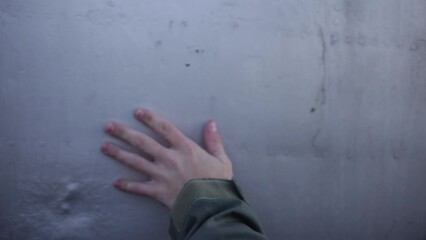 Hand of a Military Aircraft Pilot Touching His Plane at Sunset, Argentine Military Pilot standing by a Landed War Aircraft. Close Up. - Powered by Adobe