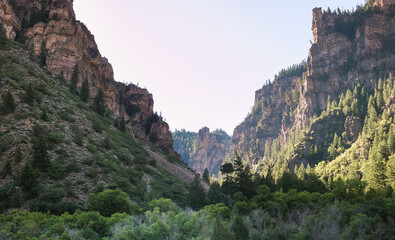 Epic cliff landscape with light on one side of the valley