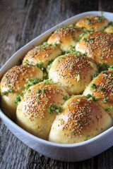 Homemade salty buns, sesame, garlic and parsley dressing