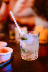 Glass of mojito cocktail with fresh lime and mint on a restaurant board