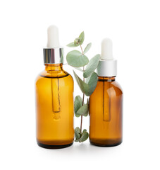 Bottles of natural eucalyptus essential oil on white background