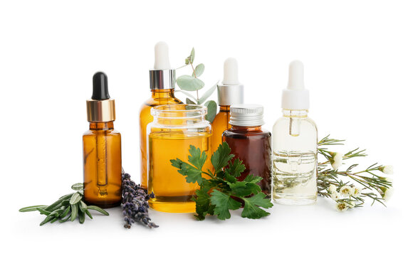 Bottles of natural essential oils on white background