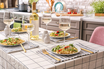 Beautiful table setting with delicious pasta and wine at home