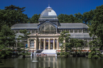 Photograph of the Crystal Palace in Parque del Retiro in Madrid with a sky full of clouds