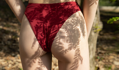Body of the beautiful young woman with light and shadow on her perfect skin posing on nature. Women...
