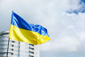 Big national flag of Ukraine on city street