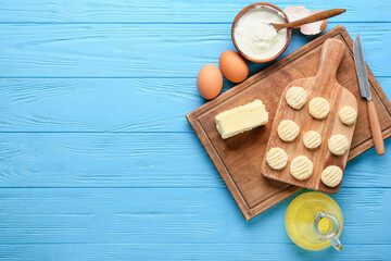 Fototapeta na wymiar Composition with raw lazy dumplings and ingredients on blue wooden background