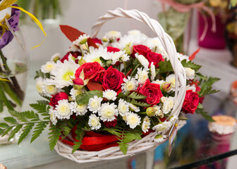 A beautiful bright bouquet of blooming fresh roses for a gift collected by an experienced florist