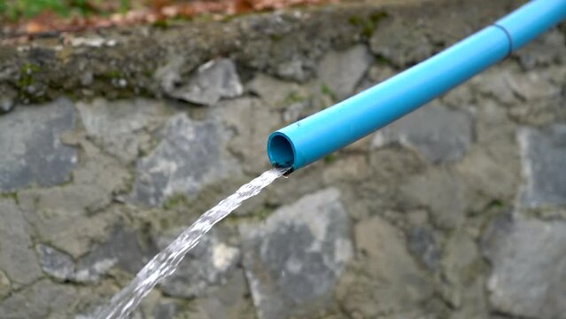 Water running from a blue water pipe, equipment agriculture.