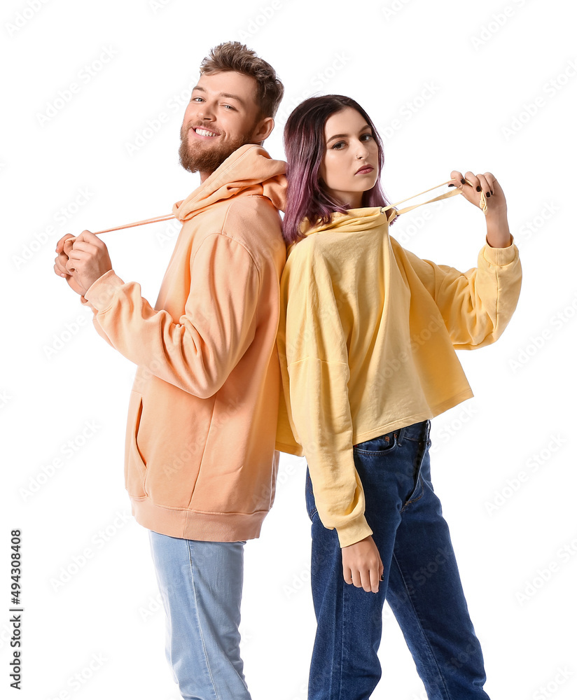 Wall mural Cool young couple in hoodies on white background - Wall murals