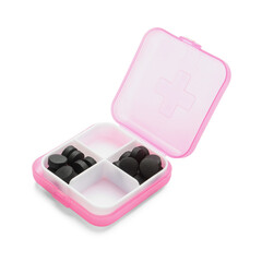 Container with activated carbon pills on white background