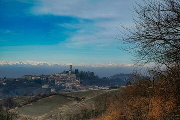 the tower and the village of murazzano in the Piedmontese Langhe, immersed in the winter snow of...