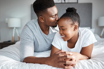 Nothing beats the feeling of being in love and being loved. Shot of an affectionate young couple relaxing on their bed together at home.