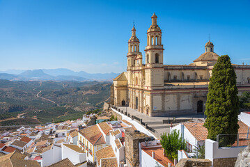 View of the beautiful white village of Olvera with the Church of Our Lady of the Incarnation, 18th century, in neoclassical style in the upper part of the city, Cadiz province, Andalusia, Spain