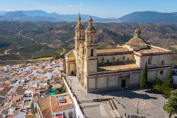 Fototapeta na wymiar View of the beautiful white village of Olvera with the Church of Our Lady of the Incarnation, 18th century, in neoclassical style in the upper part of the city, Cadiz province, Andalusia, Spain
