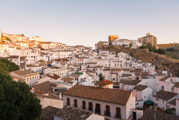 Fototapeta premium Scenic view of the beautiful and famous white village of Setenil de las Bodegas from a viewpoint at sunrise, Cadiz province, Andalusia, Spain