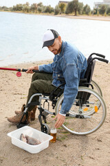 Man in wheelchair fishing on river