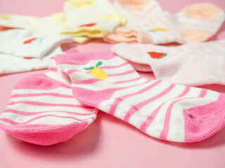 Obraz na płótnie Canvas children's colorful socks on a pink background