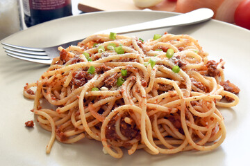 Spaghetti Bolognese with minced beef, onion, chopped tomato, garlic, olive oil, stock cube, tomato puree and Italian herb. Traditional Italian food on a plate.