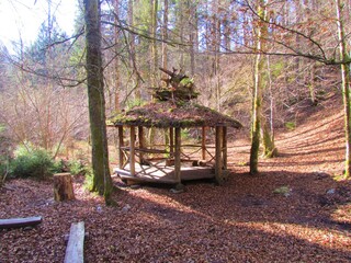 Old rustic wooden gazebo in a forest in Slovenia