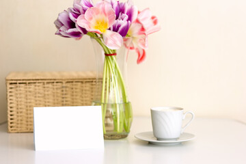 Bouquet of tulips , teacup on the table in the bright kitchen.