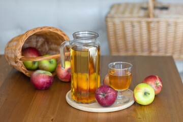 Fresh homemade organic apple juice or cider on a wooden table in a glass jug
