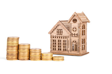 wooden house and stacks of coins isolated on a white background