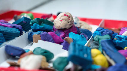 Fototapeta premium Multi colored plasticine in cardboard box for children modeling and creating. Education and development conception.