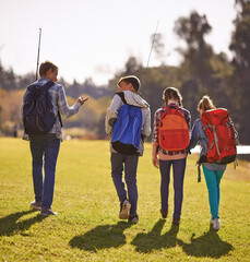 Setting off on an adventure. Shot of a group of children wearing backpacks walking together in...