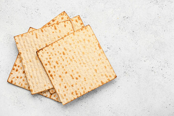 Jewish flatbread matza for Passover on light background, top view