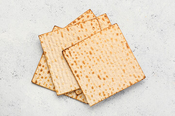 Jewish flatbread matza for Passover on light background, top view