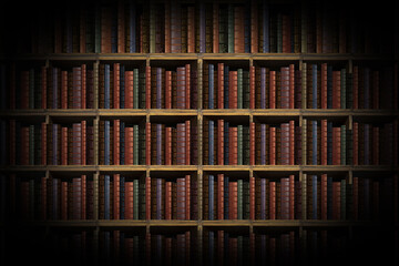 Vintage bookshelf with many old books in a library