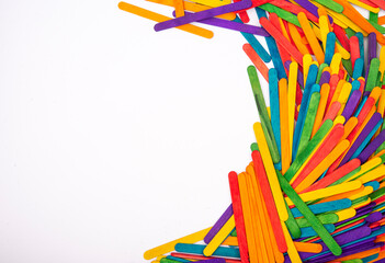 Pile of colorful wood sticks making white banner