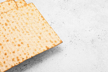 Jewish flatbread matza for Passover on light background, closeup